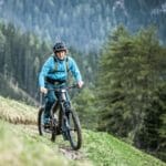 person-on-riese-muller-superdelite-mountain-ebike-in-mountains-2